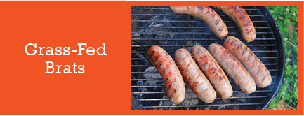 Grass-fed brats cooking on the grill